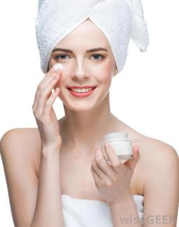 woman-in-towel-applying-lotion-to-her-face